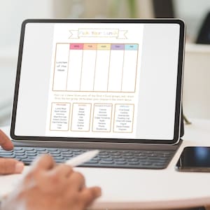 May include: A digital planner on a tablet screen with a colorful title "Pick Your Lunch". The planner is divided into days of the week and includes sections for protein, grains, fruits, and snacks.