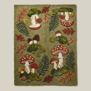 Cottagecore woodland area rug with mushrooms and botanical forest floor pattern in earthy green and rust tones