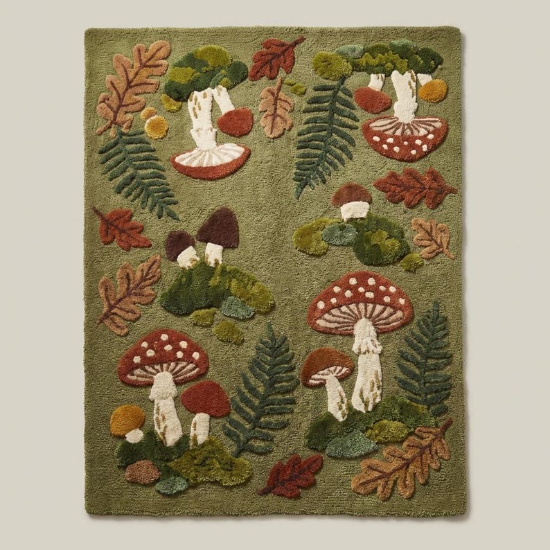 Cottagecore woodland area rug with mushrooms and botanical forest floor pattern in earthy green and rust tones