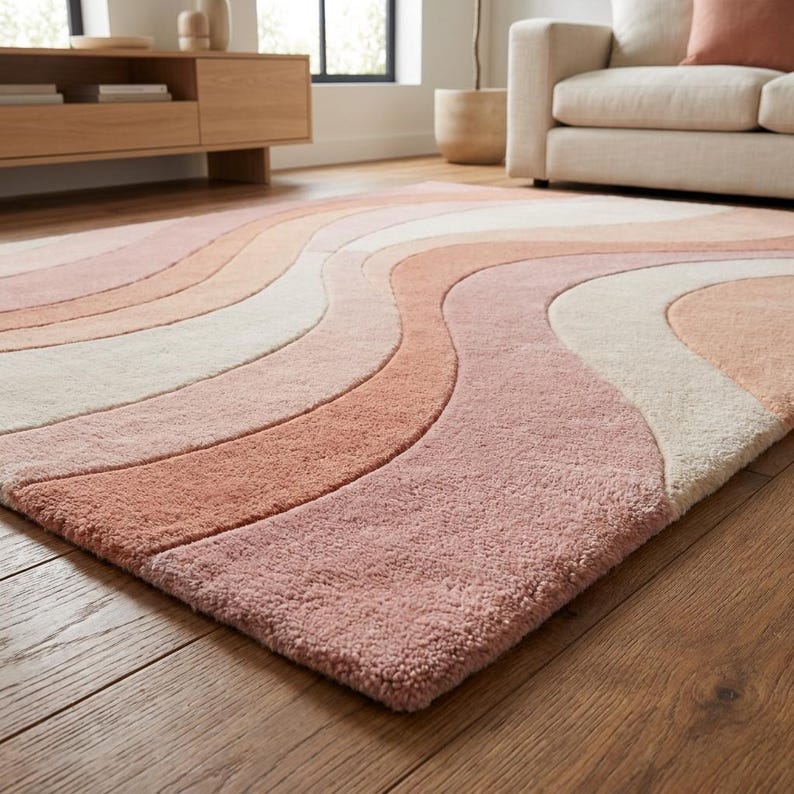Pastel abstract hand tufted rug in peach and ivory tones creating cozy modern aesthetic in home space