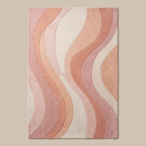 Contemporary pink abstract area rug styled under chair with soft pastel tones for modern minimalist home decor