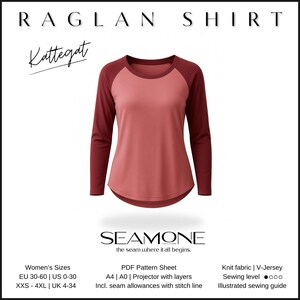 May include: A raglan shirt in a coral color with burgundy sleeves. The shirt has a curved hemline and is made of knit fabric. The text "RAGLAN SHIRT" and "Kattegat" are at the top. The brand name "SEAMONE" is at the bottom.