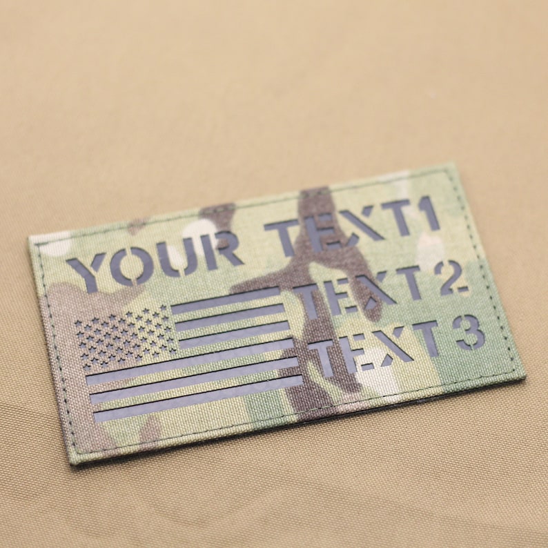 May include: A black and green camouflage patch with a black American flag and the text "YOUR TEXT1 TEXT2 TEXT3".