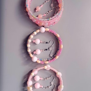 May include: A set of three ceramic mugs with a speckled, matte finish. The mugs are in shades of cream, light gray, and dark gray. Each mug has a simple, minimalist design, perfect for coffee or tea.