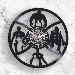 May include: Black vinyl record clock featuring silhouettes of popular superhero characters, including Captain America, Thor, Hulk, and Iron Man. The clock face is a circular design with Roman numeral markings and a black and white clock hand.