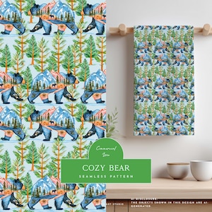 May include: A rectangular kitchen towel featuring a repeating pattern of bears with mountain and forest landscapes inside their silhouettes, set against a light blue background with green pine trees and compass motifs throughout the design.