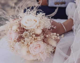 Beautiful bridal bouquet of dried flowers with infinity rose, boutonniere