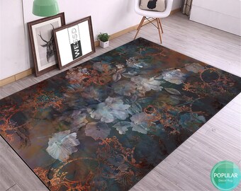 May include: A dark blue and brown area rug with a floral pattern featuring white flowers and gold accents. The rug has a vintage, antique aesthetic.