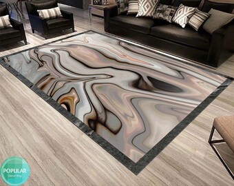 May include: Abstract area rug with a swirling pattern of brown, gray, and white. The rug has a black border and is laid out on a wooden floor.