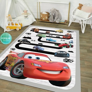 May include: A red, white, and black Cars themed play rug with a black race track and a large image of Lightning McQueen. The rug features other Cars characters like Mater, Francesco Bernoulli, and more.
