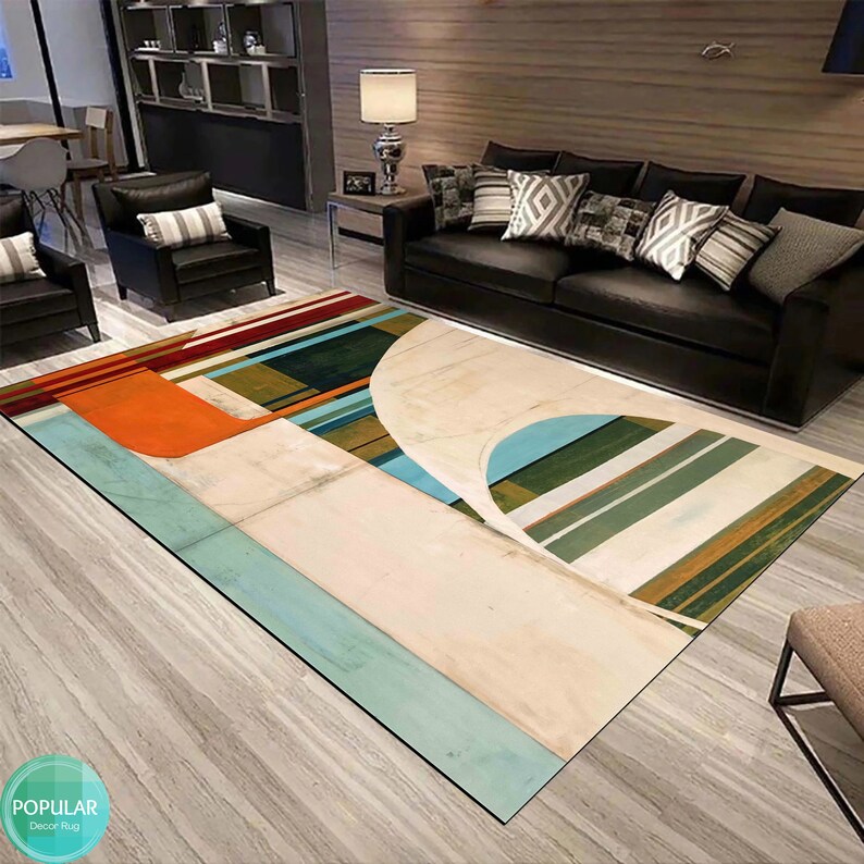 May include: Abstract geometric rug with a white background and colorful stripes in shades of orange, blue, green, and brown. The rug is laid out on a wooden floor in a living room setting.