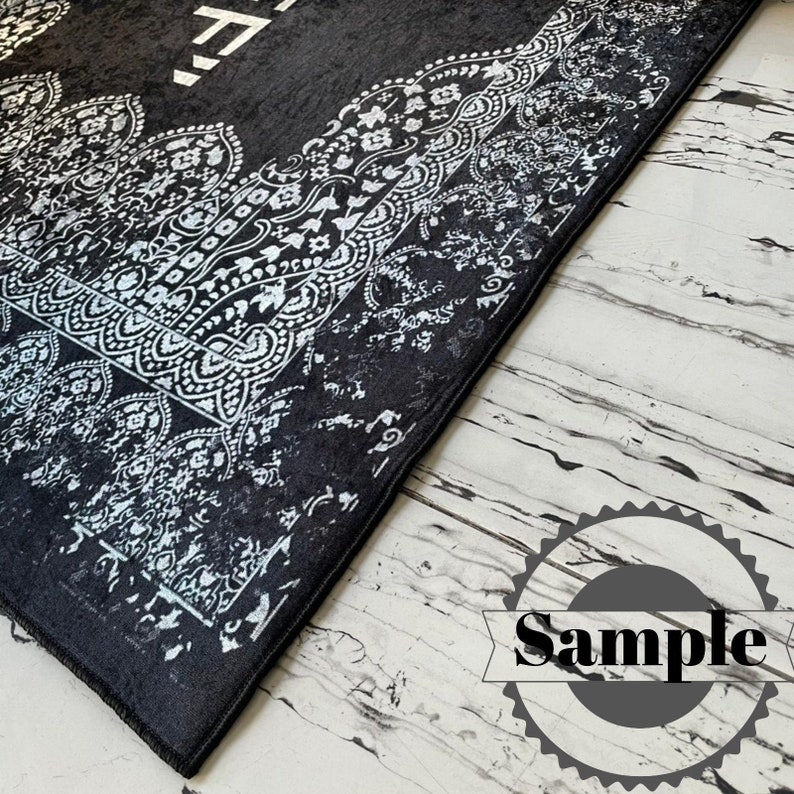 May include: Black and white patterned rug with a white border. The rug has a distressed look and is made of a soft, plush material.