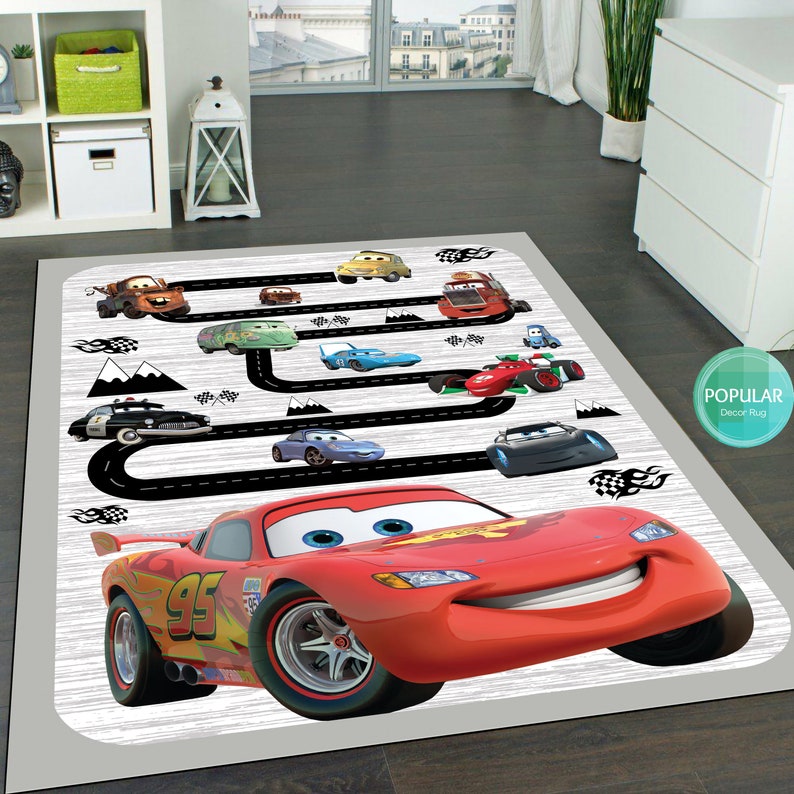 May include: A red race car with the number 95 on the side is the focal point of this rug. The car is surrounded by other cars and a black and white race track. The rug has a white background with a wood grain texture.