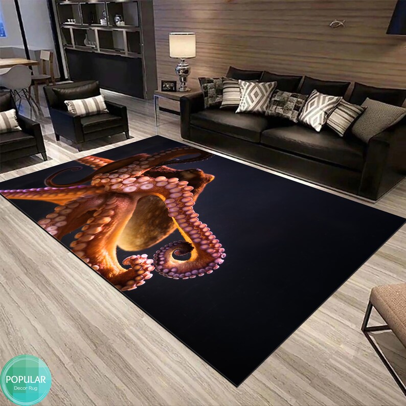 May include: A black and purple area rug featuring a large, detailed image of an orange octopus with purple tentacles. The octopus is positioned in the centre of the rug and is facing the right side of the image.