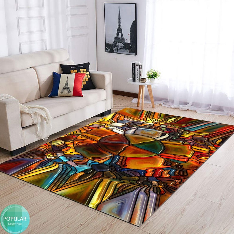 May include: A colorful area rug with a stained glass design featuring abstract shapes in shades of red, orange, yellow, blue, green, and purple.