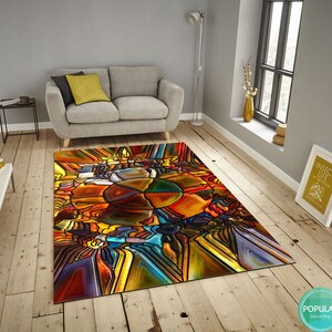 May include: Abstract stained glass style rug with a colorful design of yellow, orange, red, blue, green, and purple. The rug is on a wooden floor.
