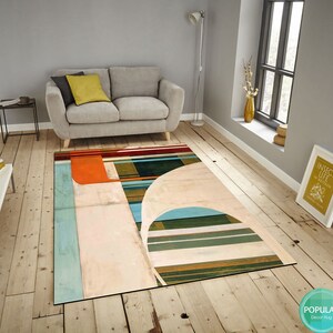 May include: Abstract geometric rug with a white background, orange, blue, green, and brown stripes. The rug has a modern design and would look great in a living room or bedroom.