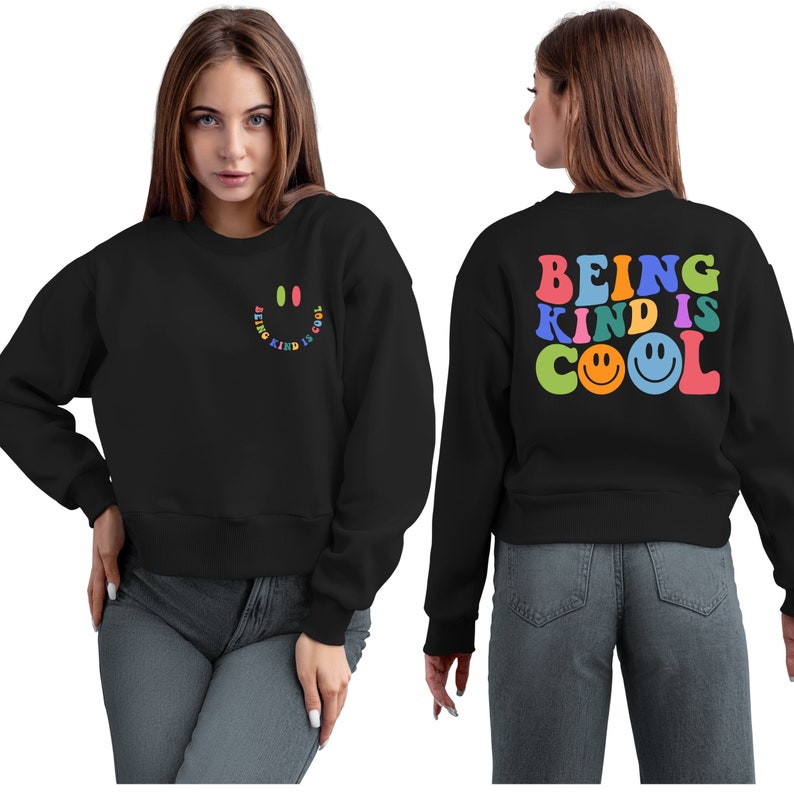 May include: Black cropped sweatshirt with the text "BEING KIND IS COOL" in rainbow colors with a smiley face on the back. The front of the sweatshirt has a small smiley face with the text "BEING KIND IS COOL" in a smaller font.