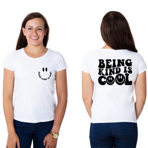 May include: White t-shirt with a black smiley face graphic and the text "Being Kind is Cool" on the front and back.