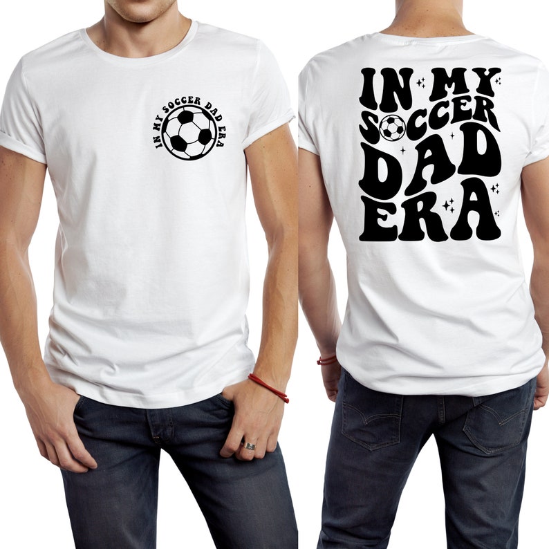 Op de afbeelding: Wit T-shirt met de tekst "IN MY SOCCER DAD ERA" op de voor- en achterkant. De voorkant heeft een voetbalafbeelding in een cirkelvormig ontwerp. De achterkant heeft dezelfde tekst in een retro lettertype.