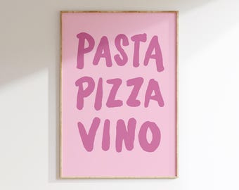 May include: A rectangular wall art print in a light wood frame featuring a light pink background with the words PASTA, PIZZA, and VINO printed in a bold, dark pink, hand-lettered style font stacked in three distinct lines centered on the print.