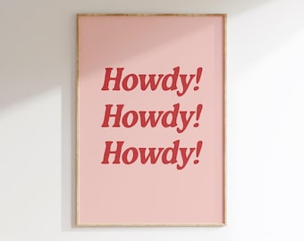 May include: A pink framed print with the text "Howdy!" repeated three times in bold red letters.