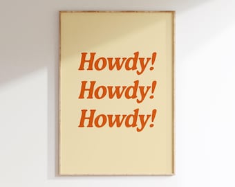 May include: A framed print with a yellow background and the word "Howdy!" repeated three times in orange text.