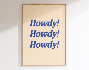 May include: A framed print with a peach background and the text "Howdy!" repeated three times in a bold blue font.