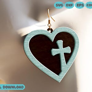 May include: A pair of teal blue heart-shaped earrings with a brown wooden cross inside each heart.