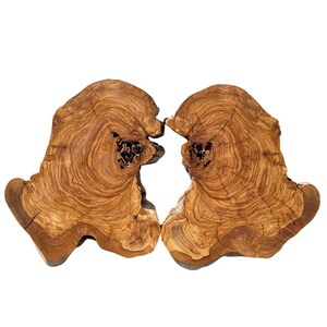 May include: Two matching, irregularly shaped wooden slabs with a natural, organic aesthetic. The slabs are a warm brown colour with intricate grain patterns and dark knots. The edges are rough-hewn, and the overall appearance is rustic.