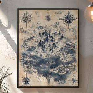 May include: A framed vintage map print depicting a detailed illustration of a mountainous landscape and coastal areas. The map features compass roses and a muted blue and beige colour palette, creating a classic aesthetic. The print is displayed on a textured wall.