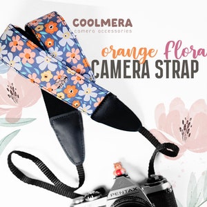 Może przedstawiać: Niebieski i pomarańczowy kwiatowy pasek do aparatu z tekstem "COOLMERA camera accessories orange floral CAMERA STRAP" na białym tle.