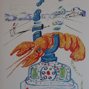 May include: Surrealist artwork depicting a lobster telephone. An orange lobster sits on a blue and white telephone base. The background shows a landscape with floating blue shapes and a distant building. Signed and numbered 43/200.