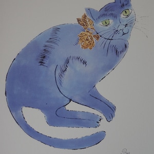 Op de afbeelding: Illustratie van een blauwe kat met groene ogen en een bloemenhalsband. Het kunstwerk, gesigneerd met "By Andy Warhol", toont een gestileerde kat met een lichtblauw lichaam en donkerblauwe contouren. De kat is versierd met een bruine bloemenhalsband.