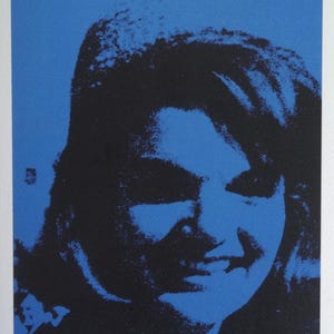 May include: A blue and black screen print of a woman's face. The print is signed "Amy Winehouse" and numbered "10/250".