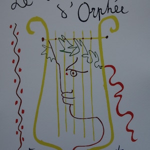 May include: A print featuring a line drawing of a face integrated into a yellow lyre shape. The text Le testament d'Orphée appears at the top in black, with Jean Cocteau at the bottom. A red wavy line and red dots decorate the left side.