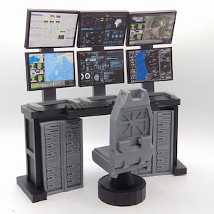 May include: A miniature command center workstation featuring a black desk with integrated server towers, a gray swivel chair, and six computer monitors displaying various data charts, maps, and technical interface graphics in a grid arrangement.