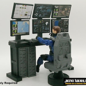 May include: A miniature command center diorama prop with multiple computer monitors displaying data. A figure in a blue uniform sits at the desk, operating the computers. The set includes a chair and a cabinet. The text "Assembly Required" is visible.