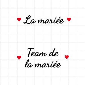 Peut inclure: Fond blanc avec l'inscription "La mariée" et "Team de la mariée" en script noir. Des icônes de cœur rouges sont placées de chaque côté du texte.