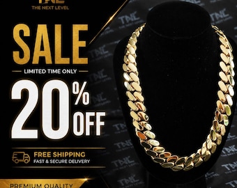 May include: A thick gold-colored cuban link chain necklace displayed on a black velvet bust. The image includes text that reads TNL THE NEXT LEVEL, SALE LIMITED TIME ONLY, 20% OFF, FREE SHIPPING FAST & SECURE DELIVERY, and PREMIUM QUALITY.