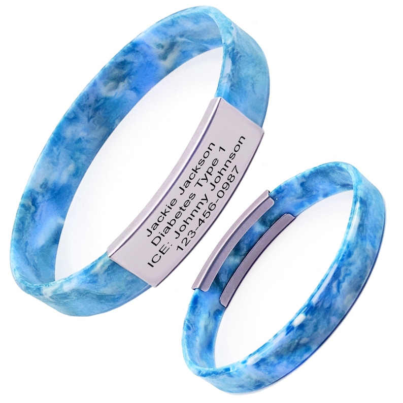 May include: Blue silicone medical alert bracelet with a silver metal tag engraved with the text "Jackie Jackson, Diabetes Type 1, ICE: Johnny Johnson, 123-456-0987".