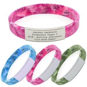 May include: Three silicone medical alert bracelets with a silver metal tag. The bracelets are in blue, pink, and green tie-dye patterns. The tag on the pink bracelet reads "Jackie Jackson Diabetes Type 1 ICE: Johnny Johnson 123-456-0987".