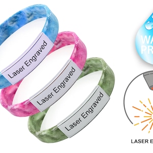 May include: Three silicone bracelets with a marbled pattern in blue, pink, and green. Each bracelet has a silver plate with the words "Laser Engraved" on it. The image also shows a water drop with the word "WATERPROOF" and a laser engraving illustration.