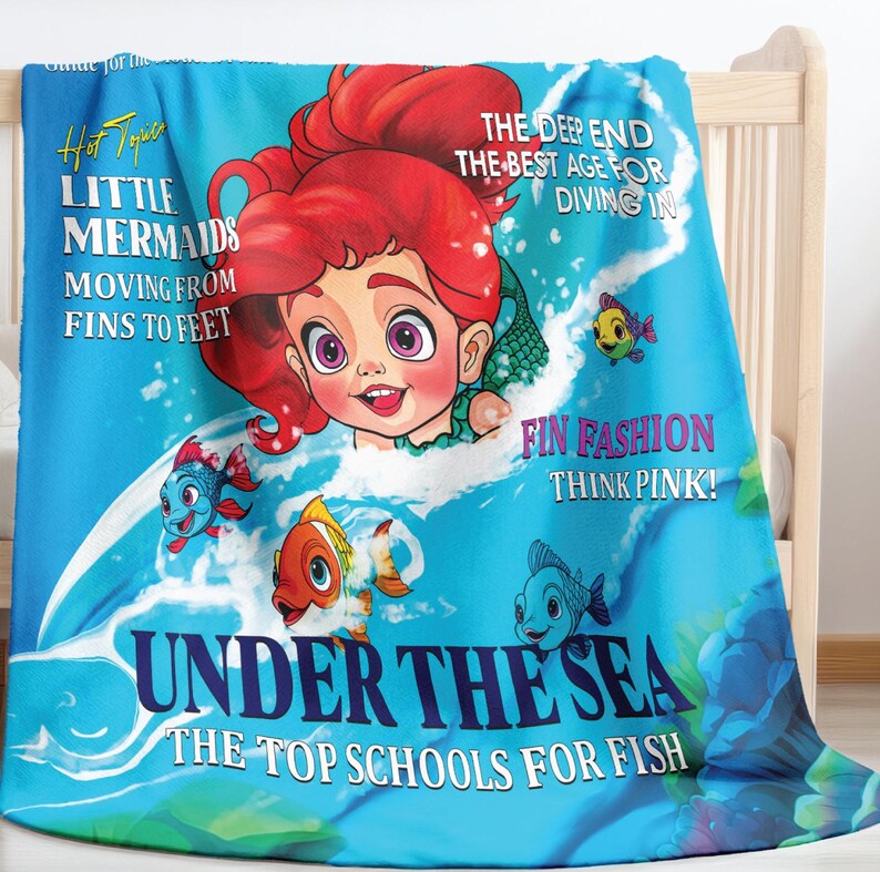May include: A blue and pink blanket featuring a cartoon mermaid, fish, and the text "Hot Topic Little Mermaids Moving From Fins To Feet The Deep End The Best Age For Diving In Fin Fashion Think Pink! Under The Sea The Top Schools For Fish"