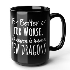 May include: Black coffee mug with white text that reads "For Better or For Worse, I happen to have a few Dragons".