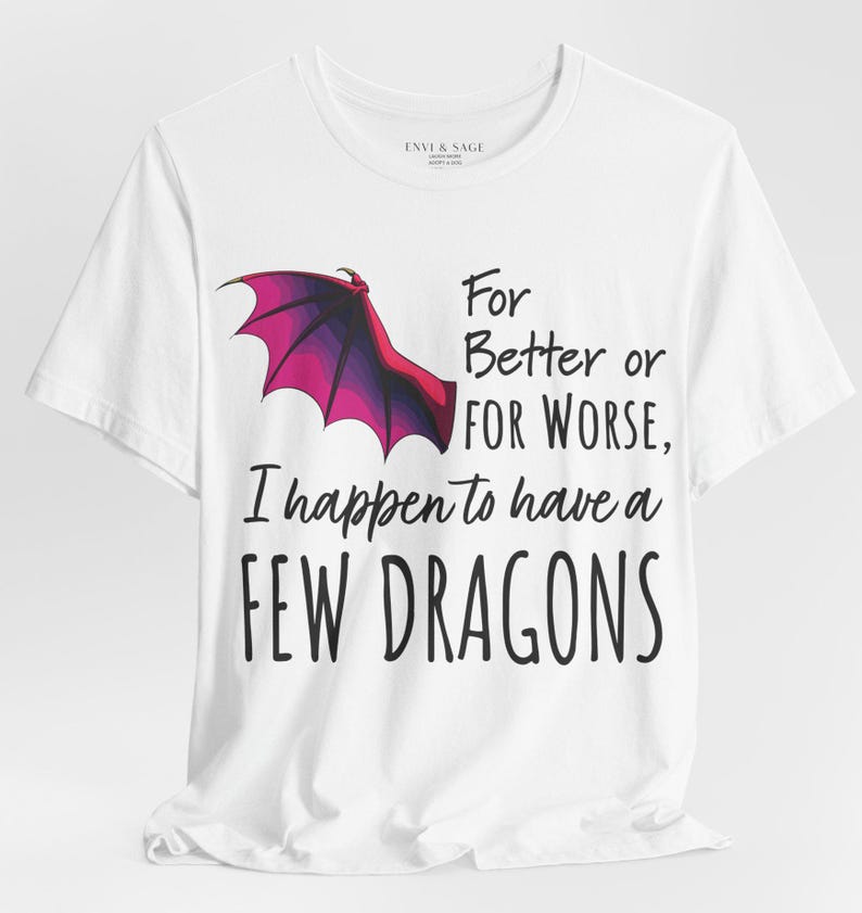 May include: A white t-shirt with a purple and pink dragon wing design and the text 'For Better or FOR WORSE, I happen to have a FEW DRAGONS'.
