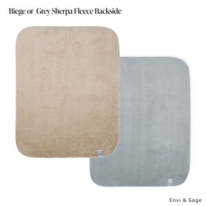 May include: Two square sherpa fleece throw blankets. One is beige and the other is light blue. The text "Envi & Sage" is printed below the blue blanket.
