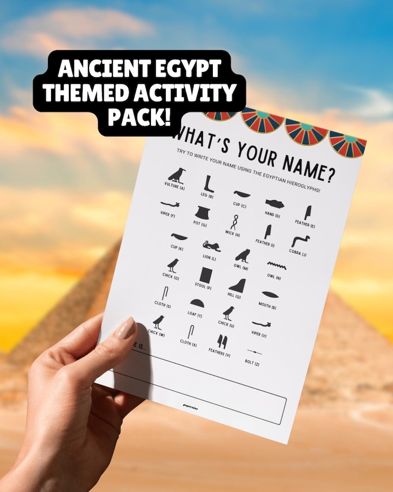 Image of a hand holding a printed out copy of one of the Ancient Egypt-themed activities. This activity is called what's your name and encourages children to use the Egyptian alphabet to write out their name.