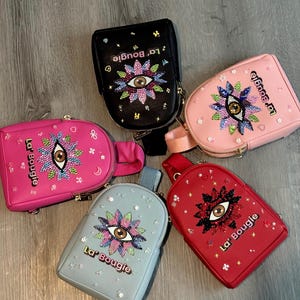 May include: A set of three ceramic mugs with a speckled, matte finish. The mugs are in shades of cream, light gray, and dark gray. Each mug has a simple, minimalist design, perfect for coffee or tea.