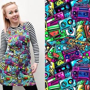 May include: A black and white striped long-sleeved shirt with a colourful mini dress featuring a retro 80s pattern of cassette tapes, boomboxes, and lightning bolts.